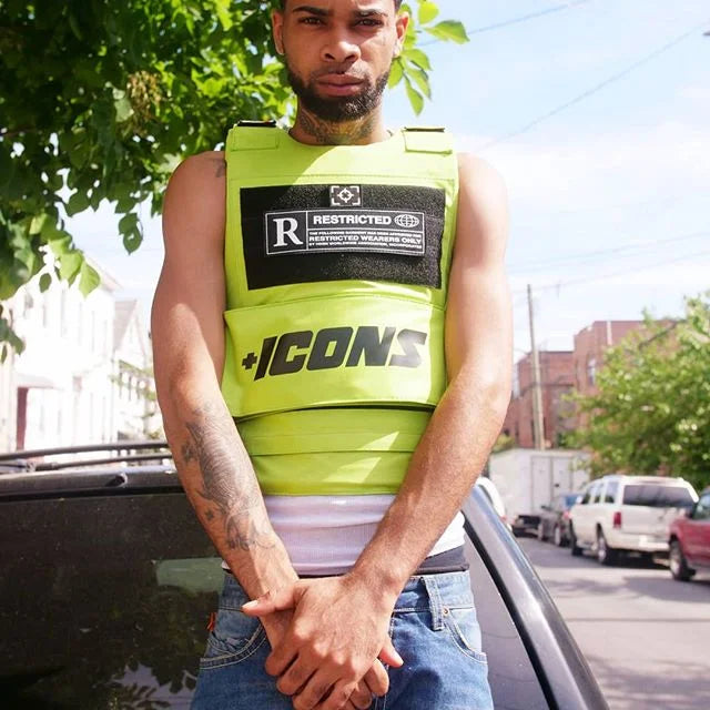Bright neon green tactical vest with black patches and bold icons lettering in 2022 hiphop street fashion design