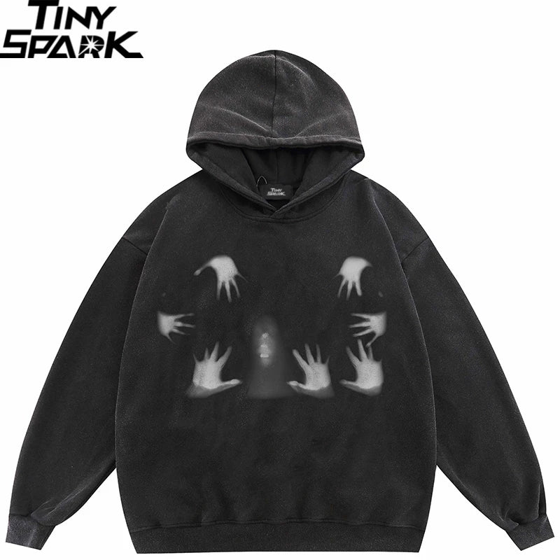 Black hooded pullover sweatshirt with a faded white handprint graphic in a 2023 hip hop oversized streetwear style