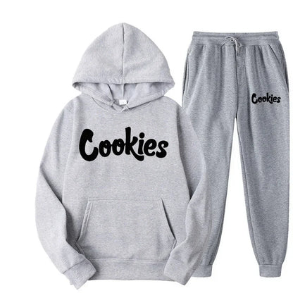 Gray cookies hoodie and matching sweatpants set with black cursive brand printing logo in a fashion trend hoodie suit jacket pants style