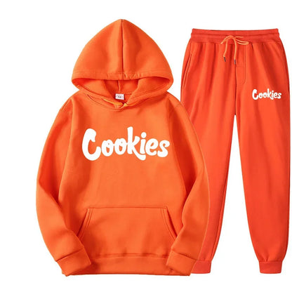 Orange hooded sweatshirt and matching joggers with white cookies brand printing logo in a fashion trend hoodie set
