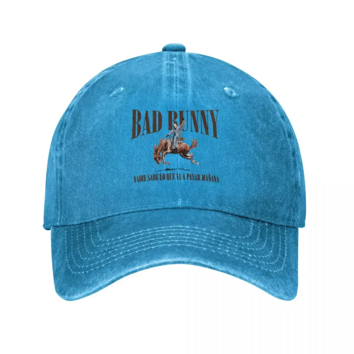 A faded blue denim music sun cap featuring a printed design of bad bunny riding a horse and tour bad bunny text