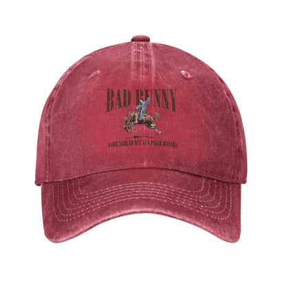 A faded maroon 2024 tour bad bunny baseball cap retro featuring bad bunny riding a horse graphic and spanish lyrics