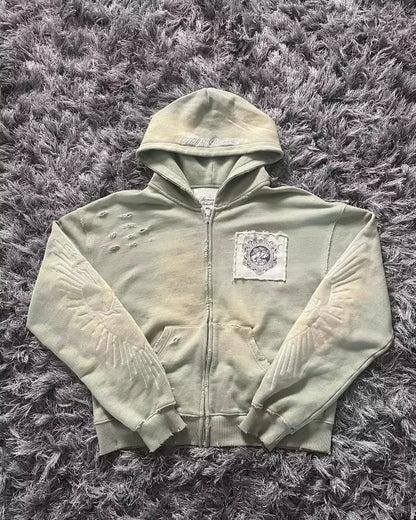 A distressed sage green zip-up sweater men y2k with embroidered wings and patch emblem in fashion oversized pattern