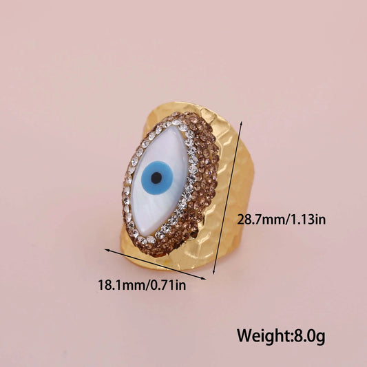 Gold-toned hop copper inlaid ring with a blue and white zircon evil eyes centerpiece and clear crystal accents