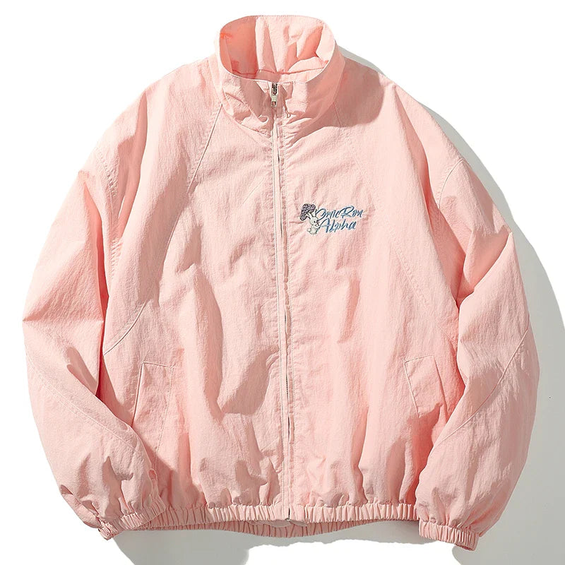 A soft pink lightweight windbreaker retro streetwear hip hop jacket with subtle embroidered logo for autumn harajuku style