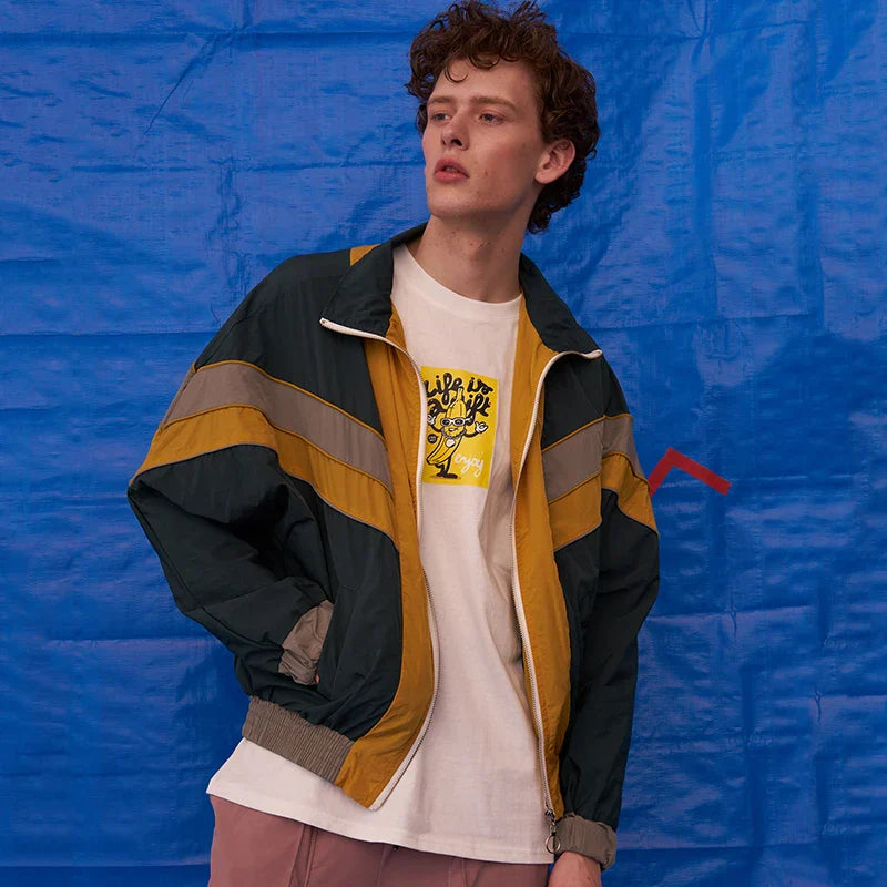 A vibrant multi-colored hip hop jacket windbreaker retro streetwear coat autumn Harajuku with green mustard yellow panels and gray stripes