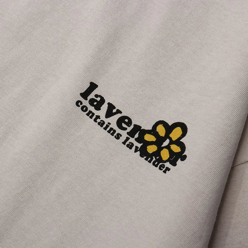 A light gray cotton shirt streetwear harajuku with a black and yellow embroidered floral graphic and laven text