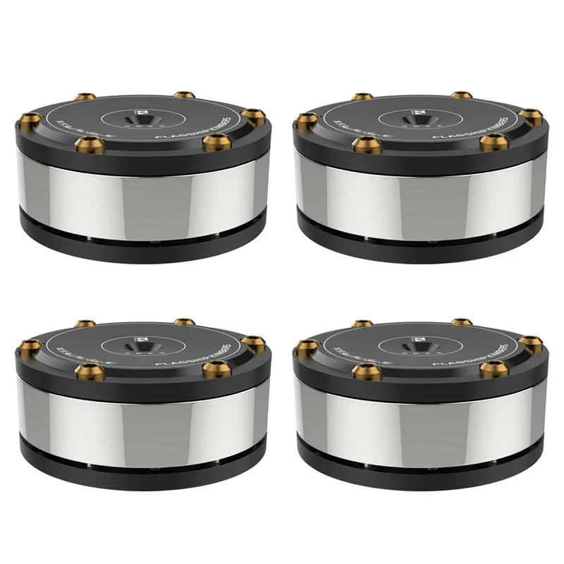 Set of four black and silver cylindrical subwoofers with gold bolts featuring audiophile shock damping and amplifier spike stand