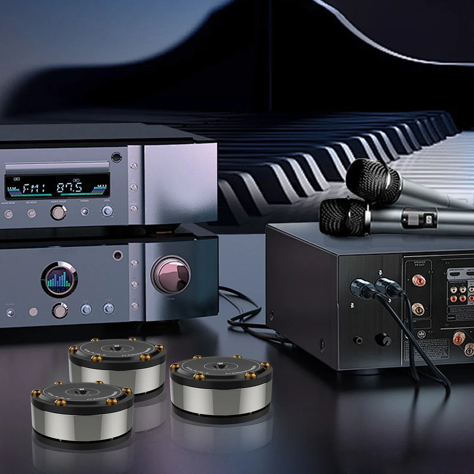 Silver and black cylindrical subwoofer drivers with gold-colored mounting screws for audiophile shock damping and amplifier spike stand