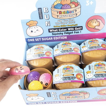 A pink glossy squishy baozi stress relief toy with a cartoon face for venting and kneading simulation in 2026