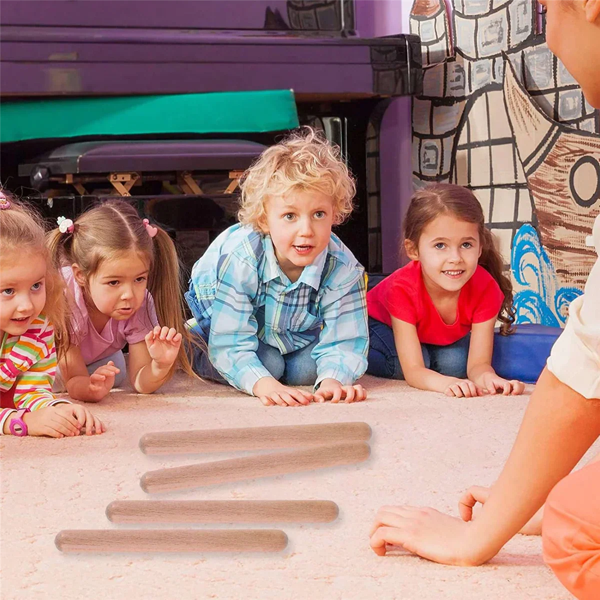 Four light brown wooden 8 inch kids rhythm lummi sticks classical wood claves lie on the floor in front of children