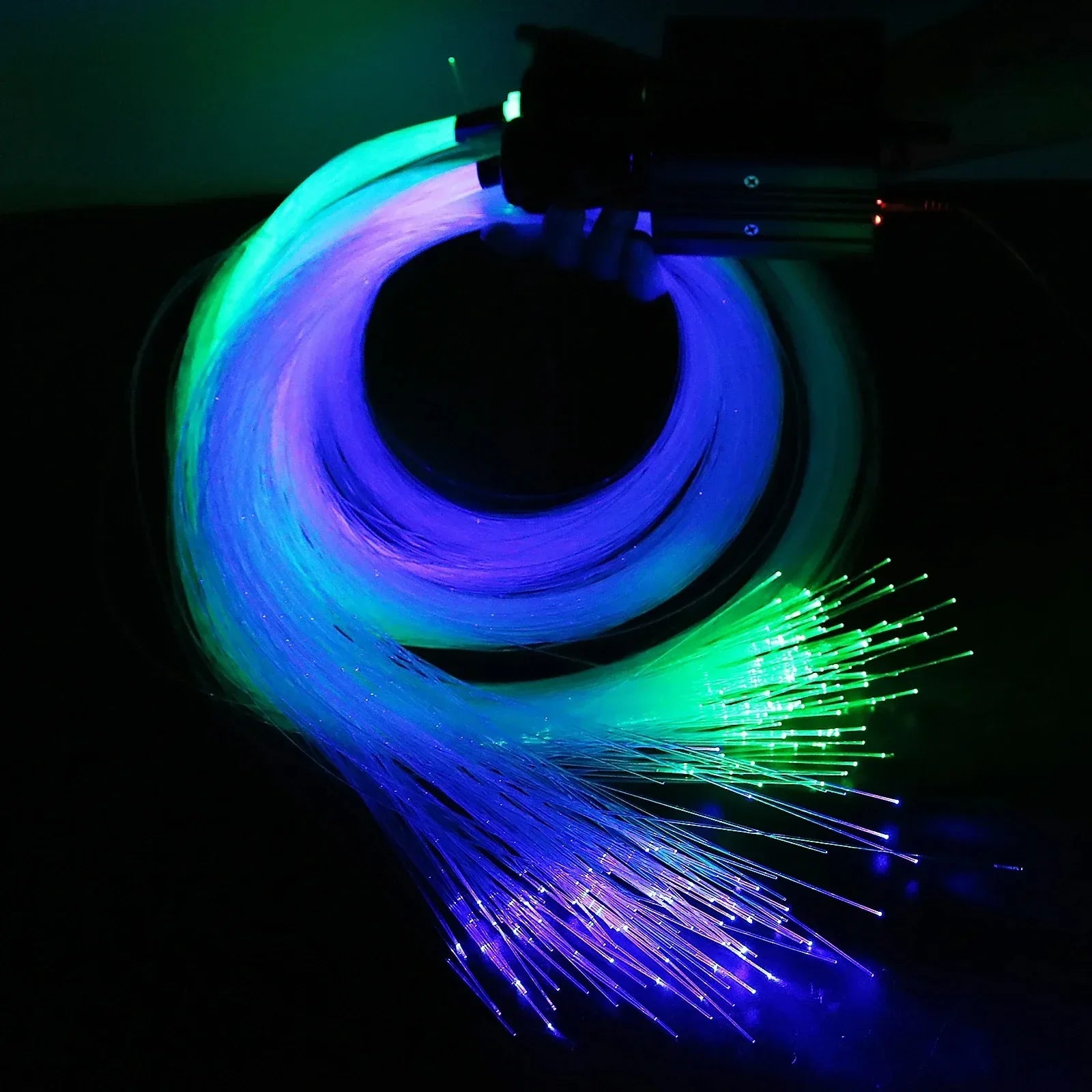 A coiled bundle of glowing blue and green fiber optic lights with dynamic rainbow tips for 20w rgb double car roof star kit