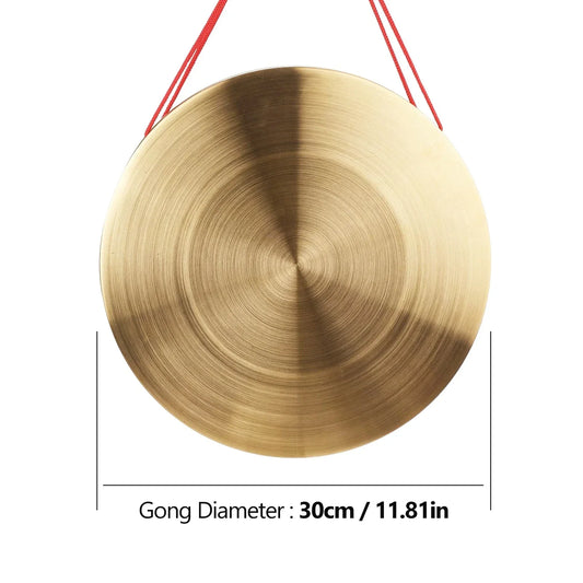 A round brass hand gong cymbal with brushed copper surface and concentric circles for chapel opera percussion use