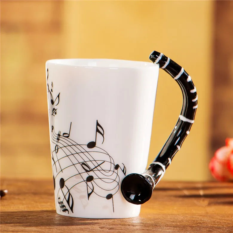 White ceramic 240ml creative music mug with black musical notes and saxophone handle, a decorative ceramic mug guitar style milk stave mug