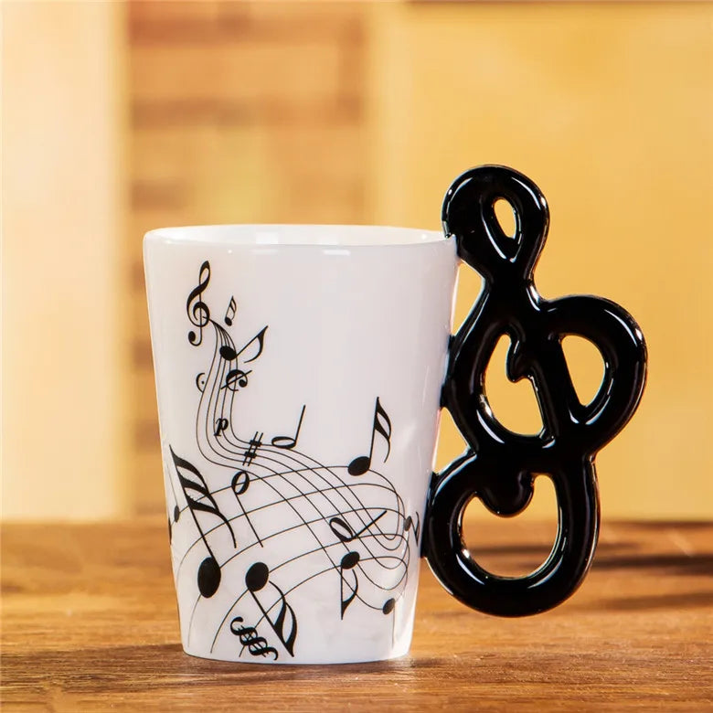 White 240ml creative music ceramic mug with black musical notes and glossy black treble clef handle for tea or milk