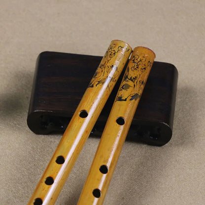 Two intricately carved 24cm chinese traditional yellow bamboo holes flute on dark wooden stand for clarinet student elementary use