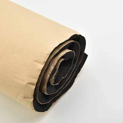 A rolled-up black felt car sound deadener pad wrapped in brown paper for car acoustic thermal insulation