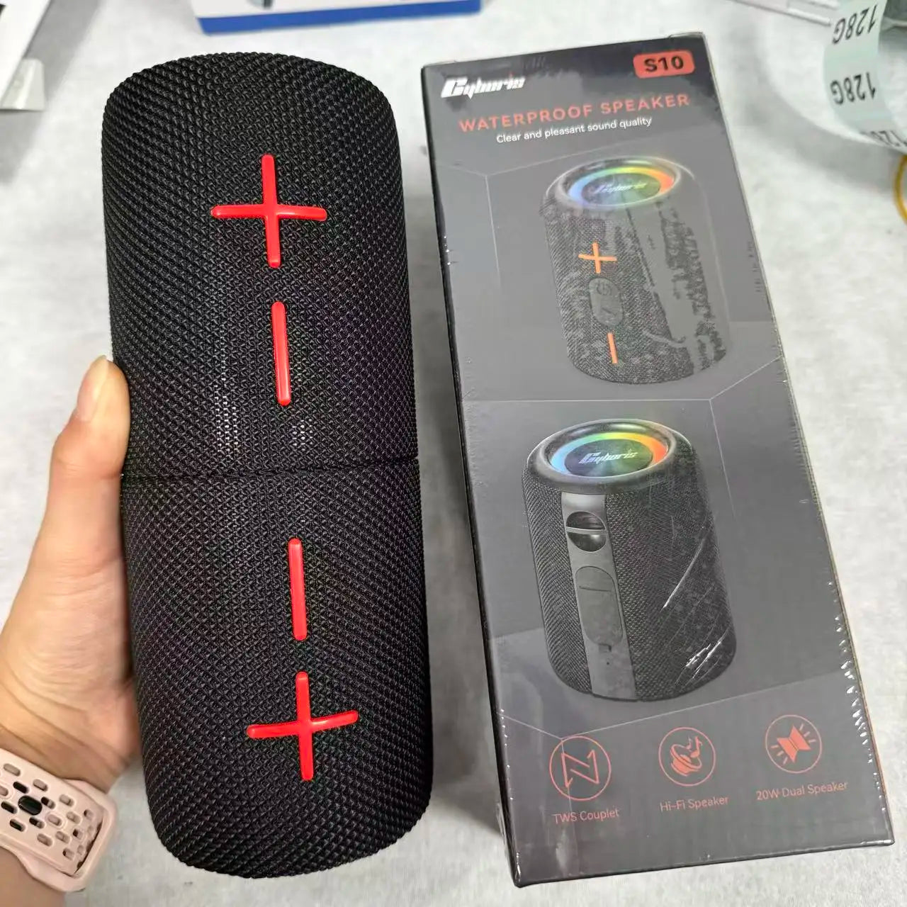 Black textured cylindrical 2in1 s10 split waterproof speaker with red plus minus buttons and rgb light aux for outdoor use