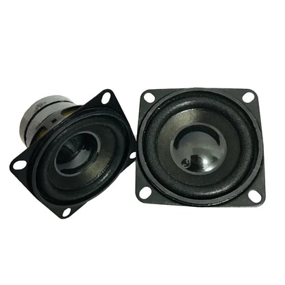 Black square-shaped mini dual magnetic speakers with glossy finish and metallic center cones for portable audio use