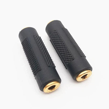 Black rubber-coated 3.5mm female audio stereo coupler socket adapter with gold-plated ends and textured grip surfaces
