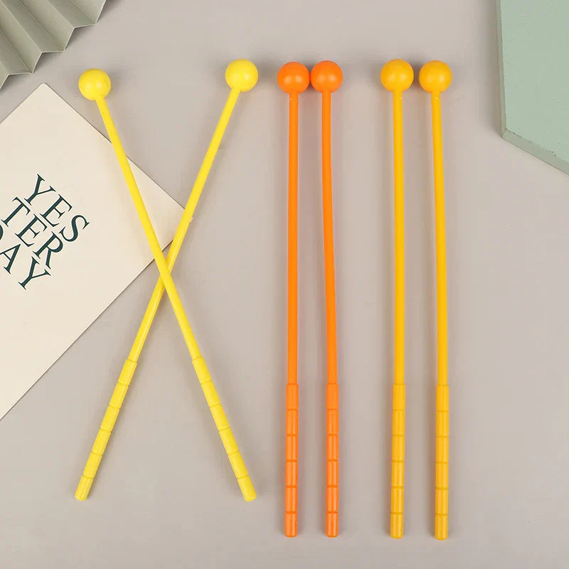 Set of colorful plastic mallets drumsticks adults with rounded yellow and orange heads for percussion use