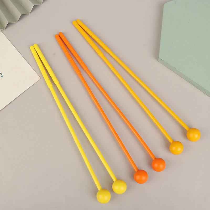 Set of two yellow and orange plastic percussion drum sticks with smooth spherical ends for adults and kids mallets drumsticks