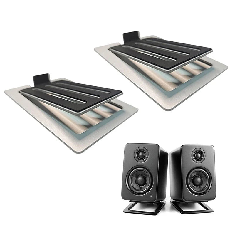 Black rectangular desktop speakers with matte finish and dual drivers mounted on matching black desktop speaker stands