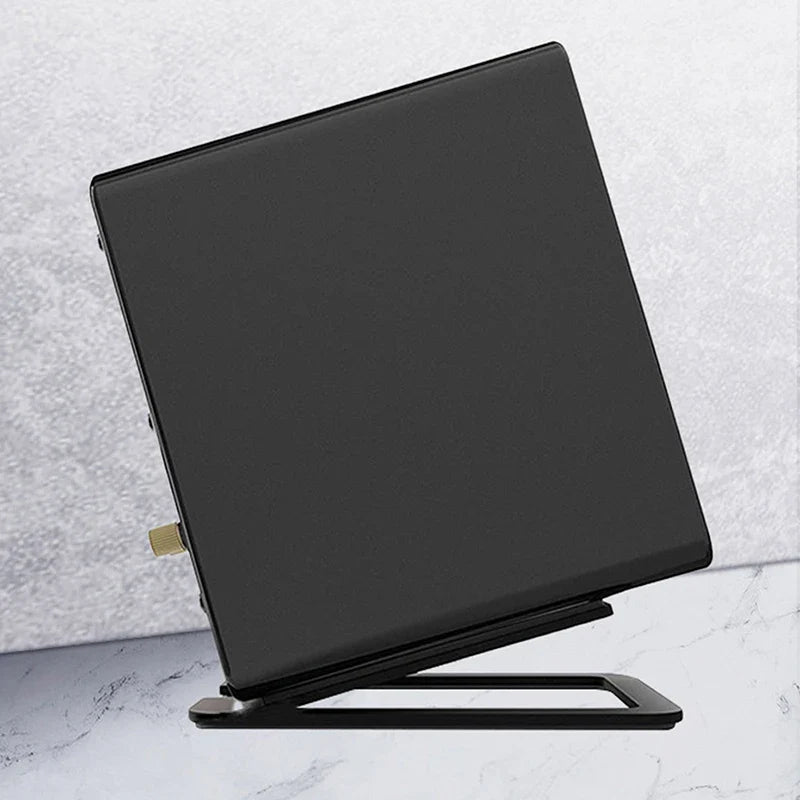 Black rectangular desktop speaker stand with metallic gold accent and foam padding for enhanced sound and shock absorption