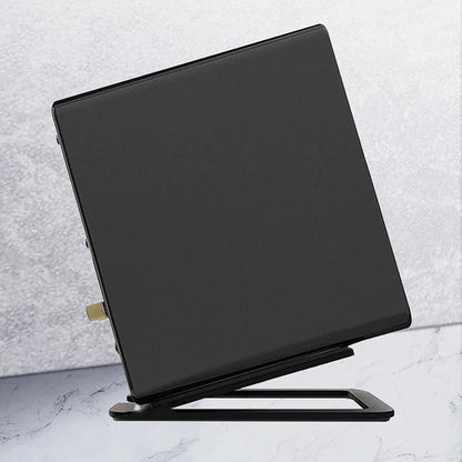 Black rectangular desktop speaker stand with metallic gold accent and foam padding for enhanced sound and shock absorption
