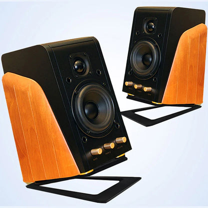 Black and wood-finished desktop speaker with gold control knobs on a desktop speaker stand for enhanced sound and shock absorption