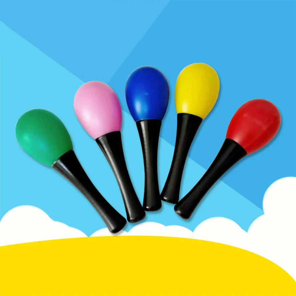 Five colorful plastic maracas sand with black handles in green pink blue yellow and red for percussion musical instruments