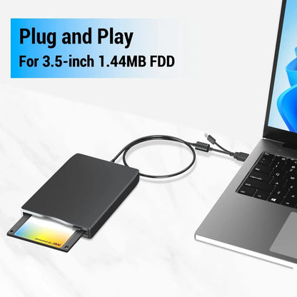 Black rectangular 3.5 inch external floppy disk drive enclosure with disk reader connected by usb cable to laptop