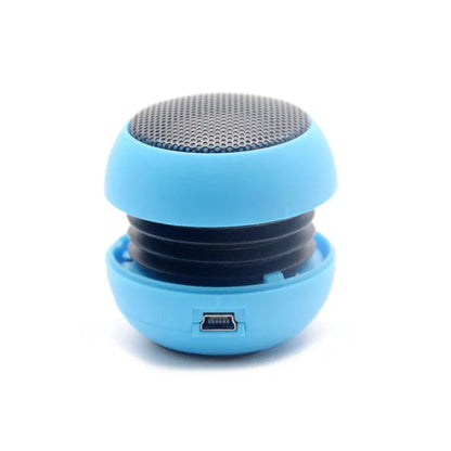 Blue compact portable speaker with mesh grille and usb port for portable speaker travel and box outdoor sports use