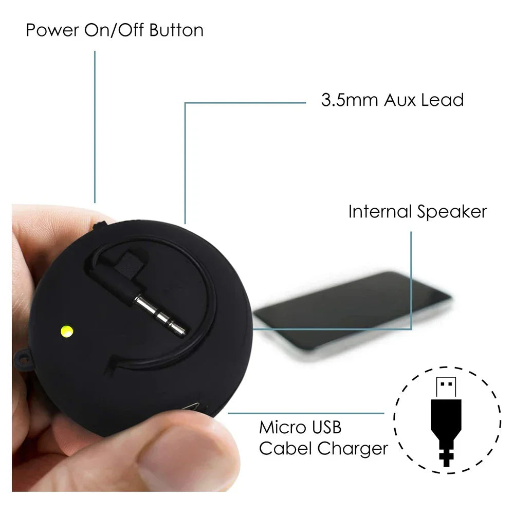 Black circular portable speaker with 3.5mm aux and micro usb charger port for portable speaker travel and box outdoor sports use