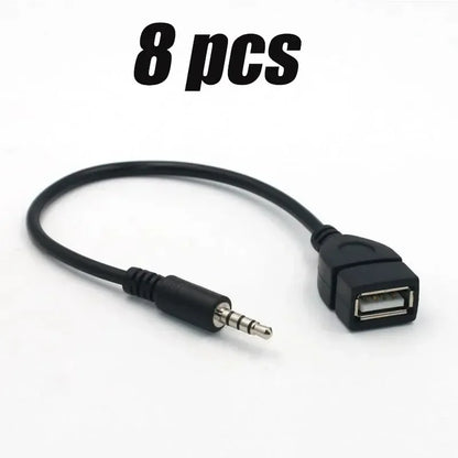 Black car aux usb audio cable with compact molded plastic housing and metallic connector pins for cable car electronics