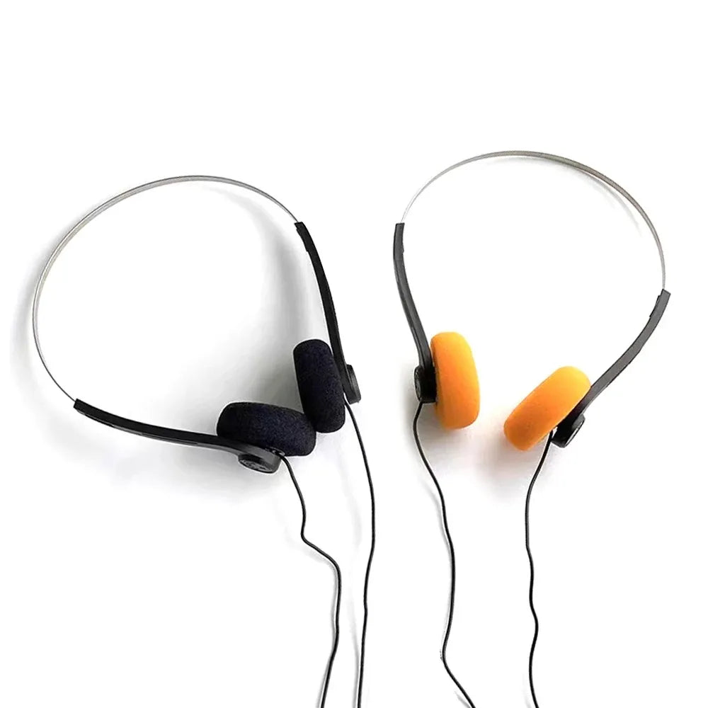 A pair of black and orange universal headphone music with foam cushions, metal frame, wired for sports fashion noise cancelling headphones helmet