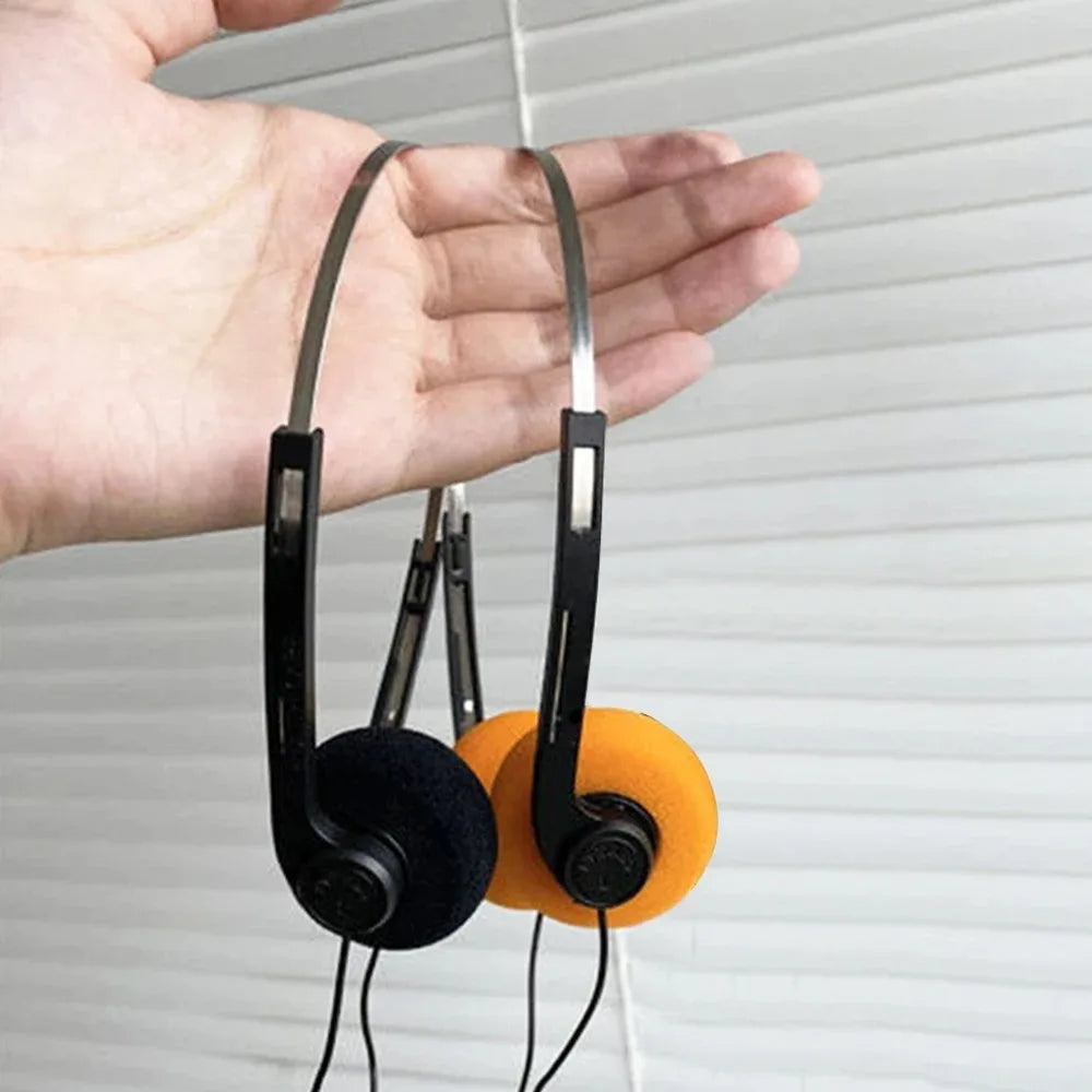 A pair of black and orange universal headphone music wired noise cancelling headphones helmet with metallic headband