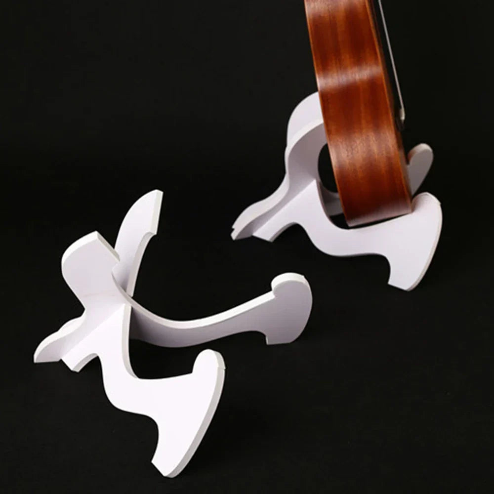 White plastic accessories foldable holder displaying a brown wooden acoustic guitar in styles portable instrument rack vertical ukulele display
