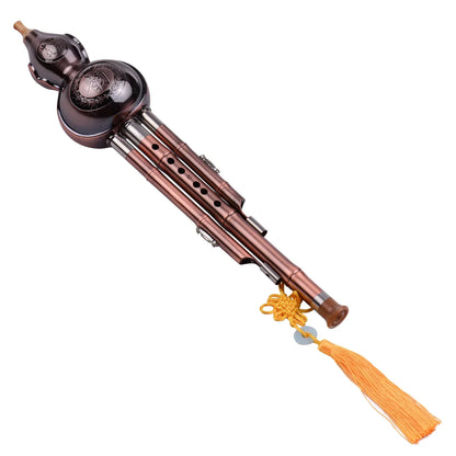 A traditional dark brown hulusi gourd cucurbit flute aluminum with copper plated pipes and silver metal joints