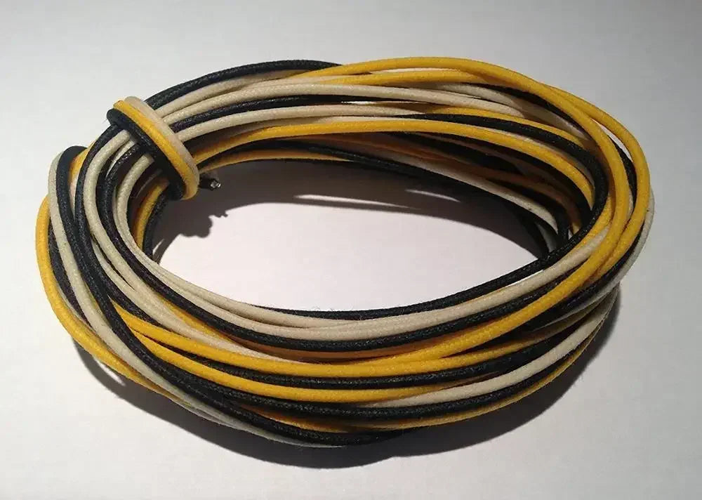 Coiled bundle of black beige and yellow gavitt fabric pre-dyed 7-strand push 22-watt retro style guitar cords