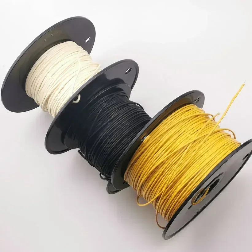 Three spools of off-white black and yellow 7-strand push gavitt fabric pre-dyed 22-watt retro style guitar cord