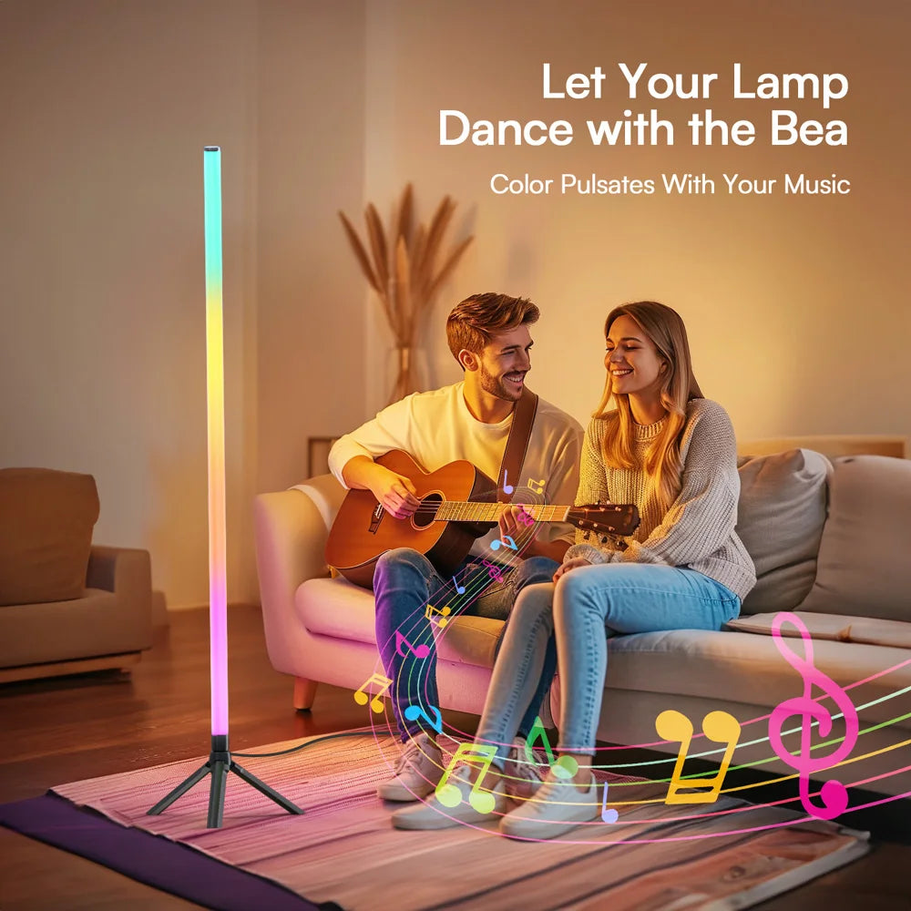A tall slender luminous floor ambient led lamp with tri-legged base and ambient light rgbic pulsing to rhythm sound pickup