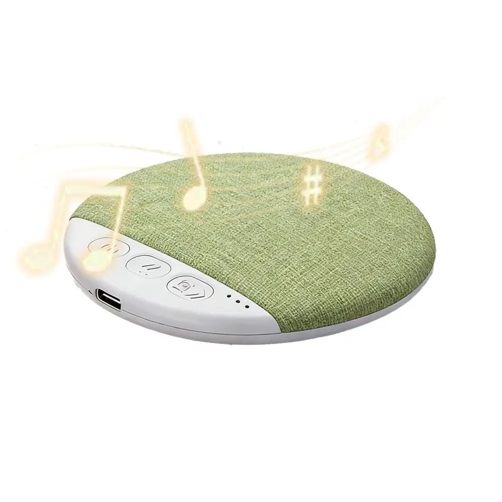A sleek circular pillow speaker with green fabric top white base control buttons usb port for surround sound bluetooth white noise timer