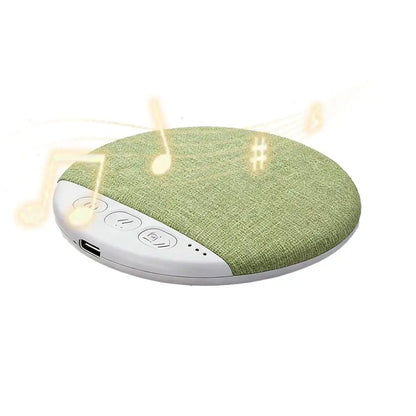 A sleek circular pillow speaker with green fabric top white base control buttons usb port for surround sound bluetooth white noise timer