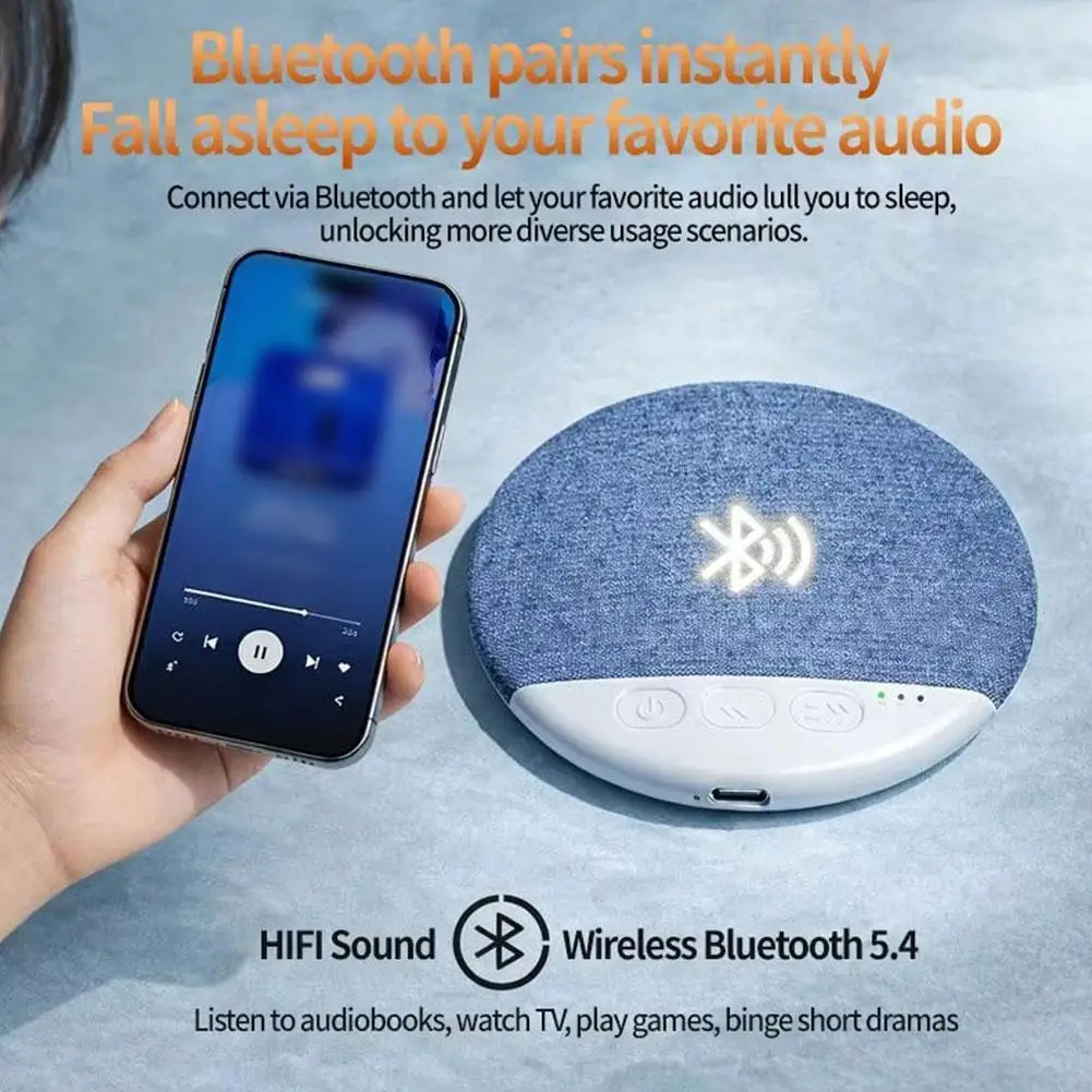 Blue textured circular surround sound bluetooth pillow speaker with white control panel and wireless charging symbol