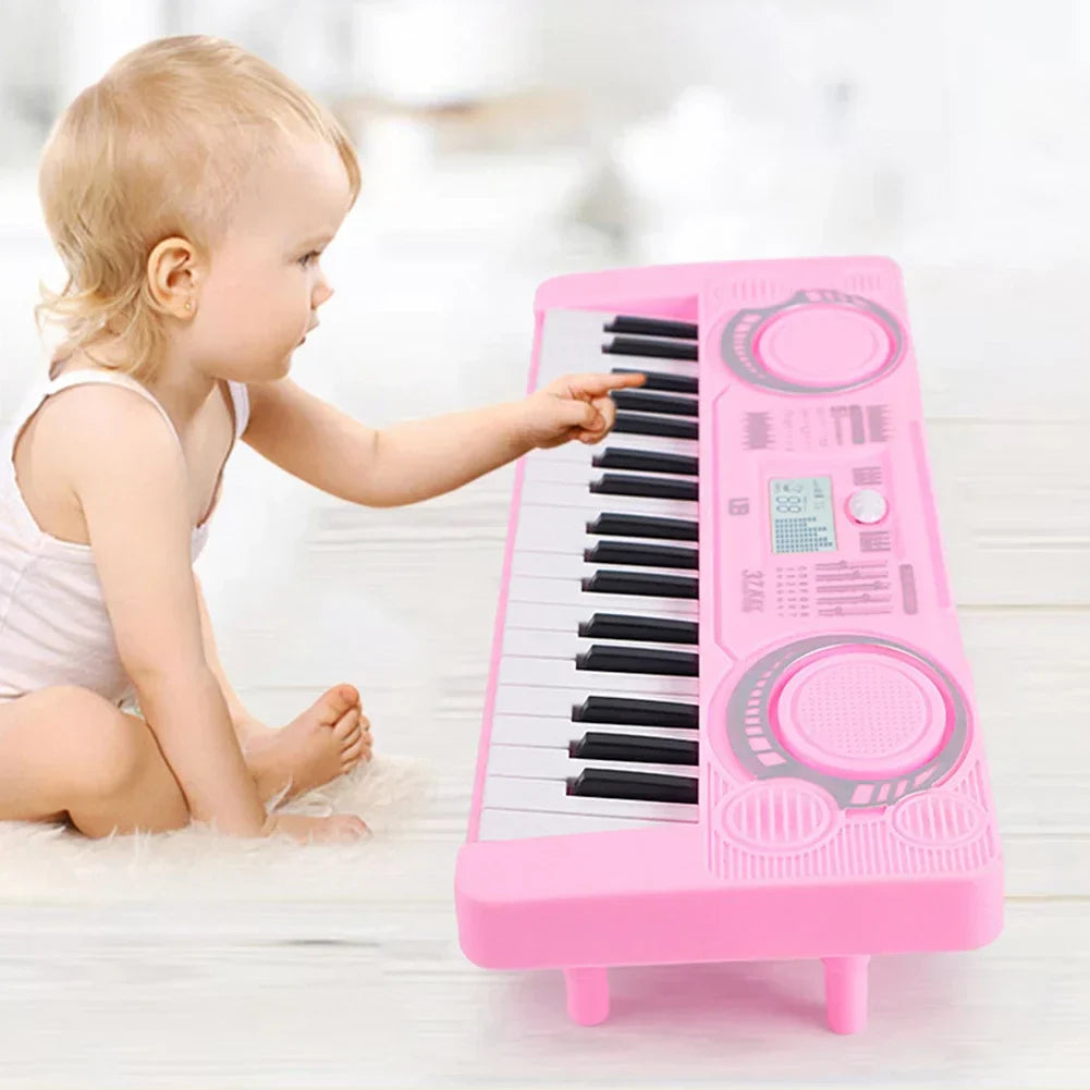 Pink plastic electronic piano keyboard with 37 black and white keys and circular dials portable educational toy musical instrument organ