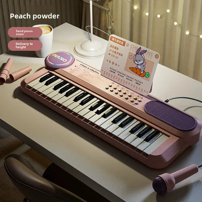 Peach powder-colored kids piano keyboard with black and white keys purple speaker grille and matching microphone music score for early learning interactive play