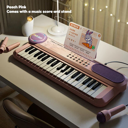 Peach pink kids piano keyboard with black white keys purple speaker grille and matching microphone for early learning interactive play