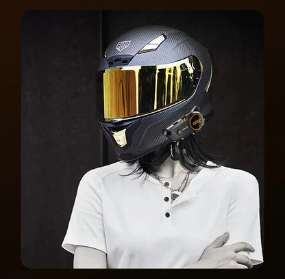 Black carbon fiber bass motorcycle helmet with gold-tinted visor and integrated headset stereo bluetooth system
