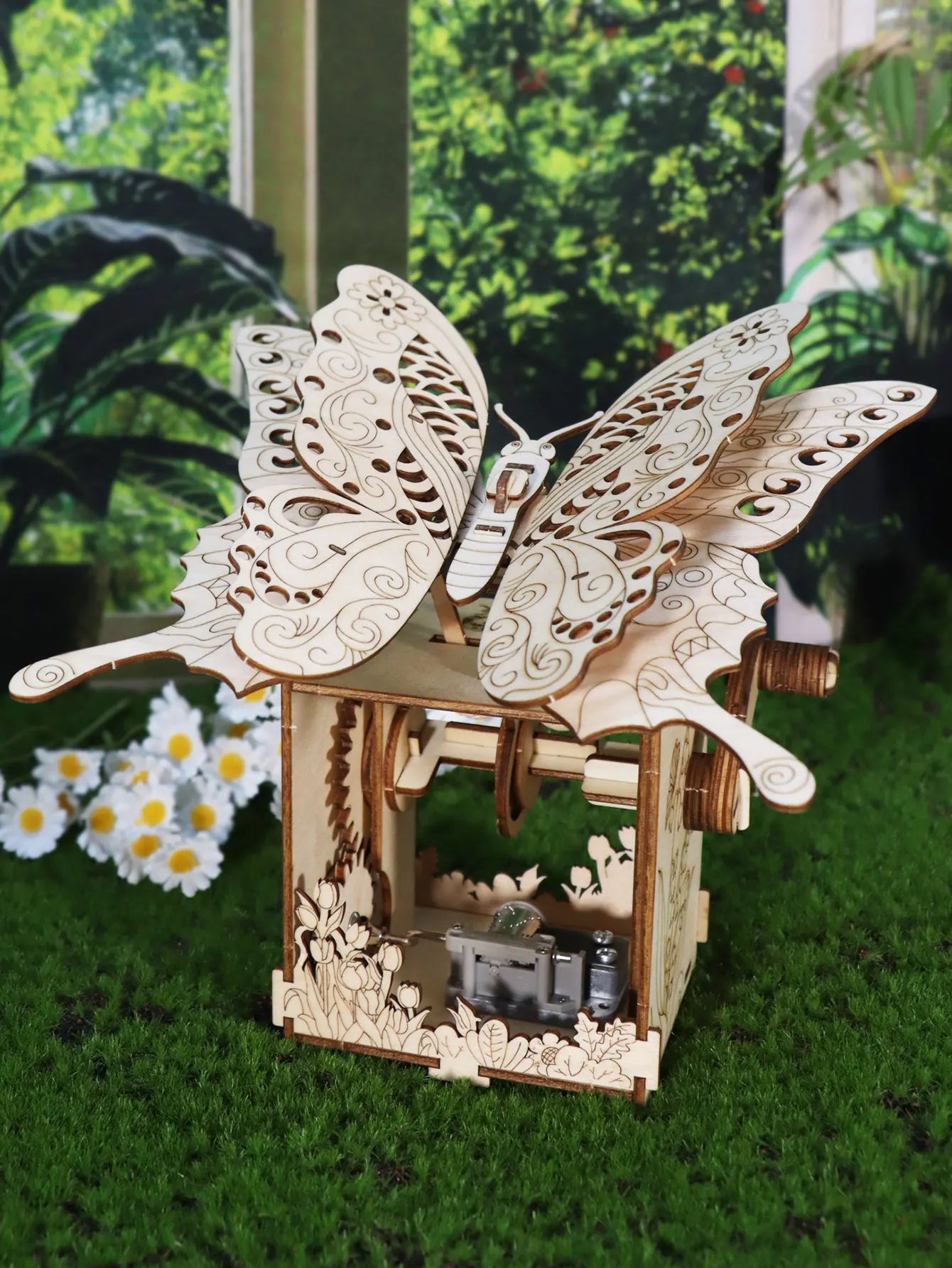 A delicate wooden puzzle hand butterfly with ornate wings on a matching butterfly music box sunshine handmade assembly